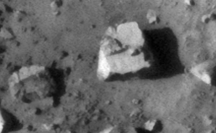 Square block with strange features on the flat face