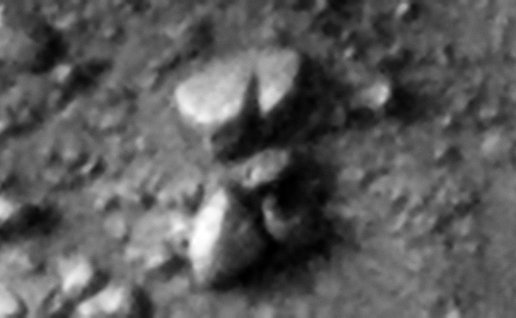 Rounded megalithic block with v-shaped slot cut into the side