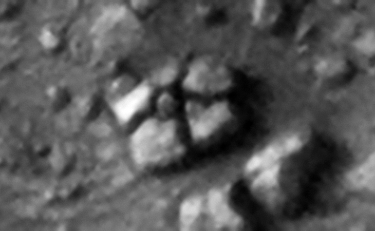 Five megalithic blocks arranged around a smaller block