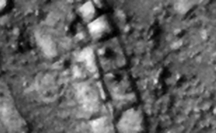 Two rows of megalithic blocks or slabs, two have smaller knobs or features on top