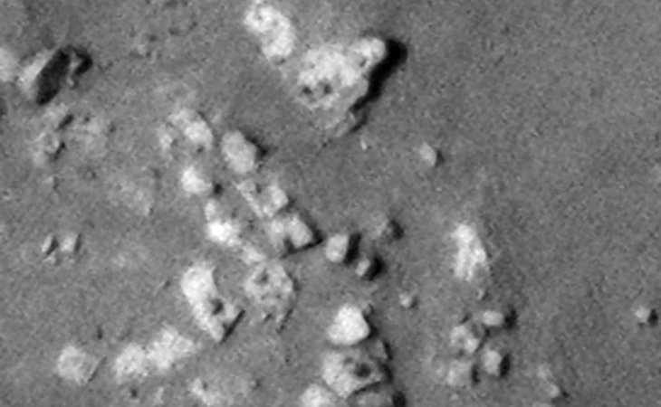 Close-up of the circular structure showing the megalithic blocks with knobs, note the parallel rows and uniform spacing of the blocks