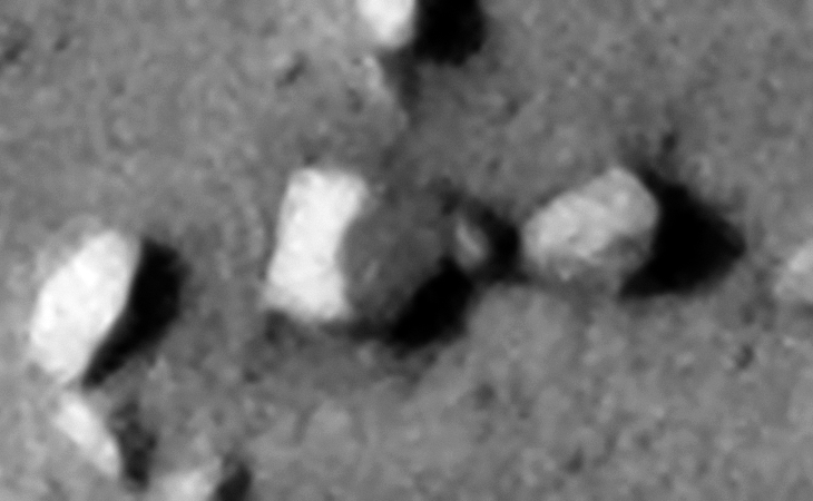 Eroded rectangular megalithic bloc, two sides are visible