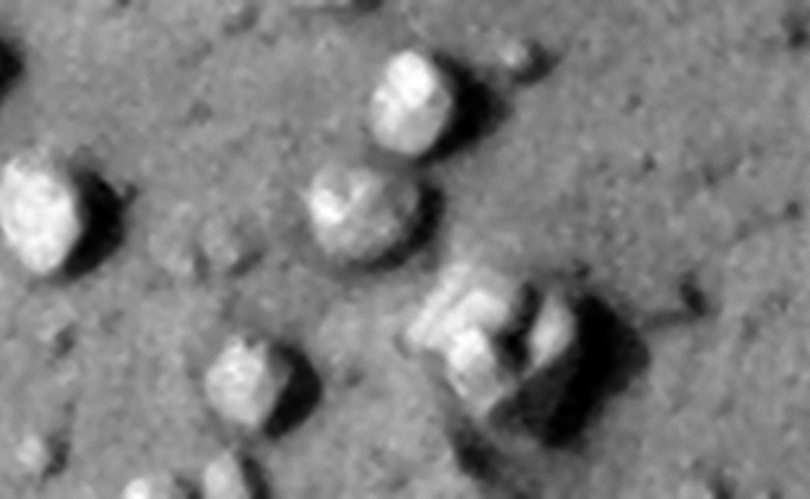Is the object located bottom right a megalithic feature or wreckage of some type of machinery or technology? Note the square cube on top of the larger bent object. Check out the block top center with the bright rectangular surface carved into the one side