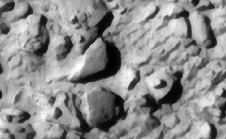 Megalithic blocks, one chevron shaped the other rectangular, with small features or knobs in the centers