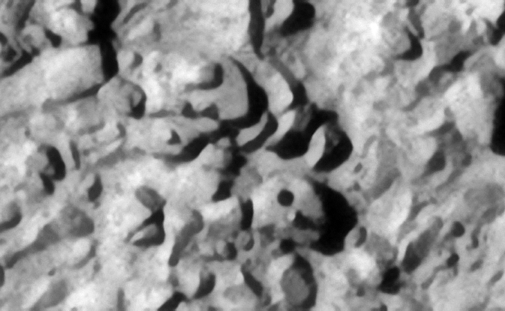 Another perfect hole in the block located to the bottom right, a smaller conical feature is also seen next to the hole. Note the arrangement of three similar sized objects to the left of the block with the hole. A small pyramidal feature or knob is seen on the object located to the top left. Note the perfectly defined edges of the objects located to the middle top
