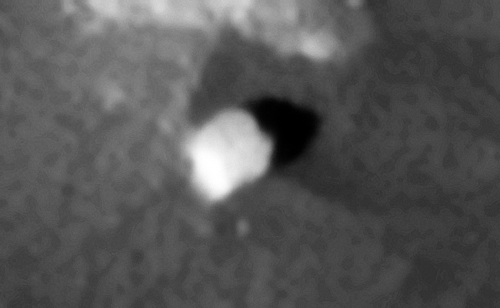 Megalithic block with rounded corners, possibly part of a structure