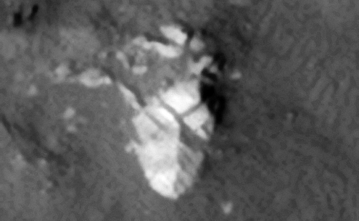 This object looks like a sculpture of a face, the two square eyes are located to the top between the 'V'-shape forehead or perhaps this is part of a statue or machine