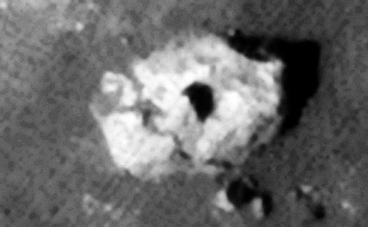 Destroyed statue or sculpture with triangular feature on top