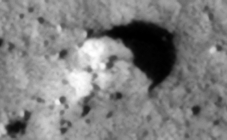 Eroded megalithic slab or metallic wreckage? Note the smaller feature in the center of the surface