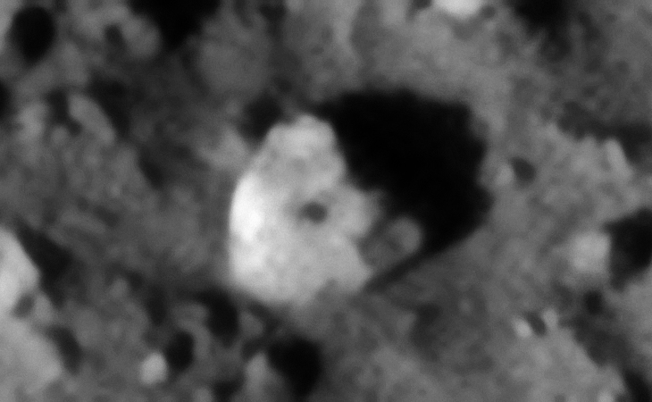 Semi-circular object with smaller dome in the center. Note the right-hand corner of the larger object which looks like a step