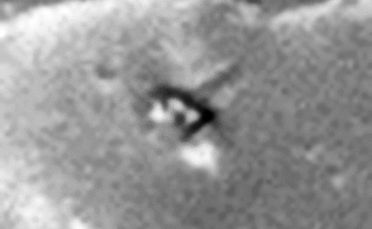 Smashed saucer-shaped craft with impact trench to the right?