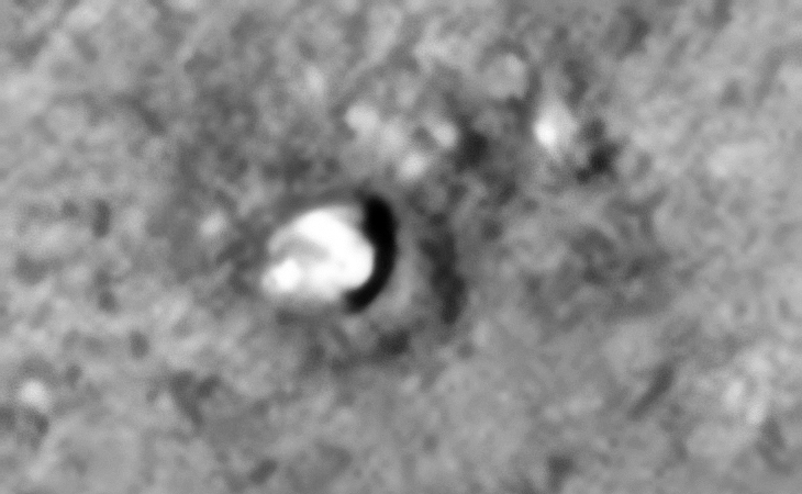 Smashed saucer-shaped craft impact sand mound to the right?