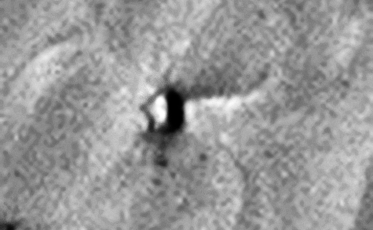 Triangular craft and impact trench to the right?