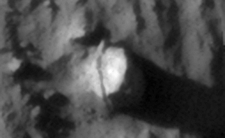 Megalithic block with weird ridge-line embedded in side of hill