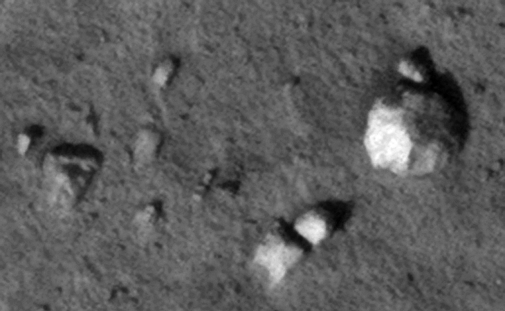 Triangular object to the left with multi-sided diamond-shape object to the right