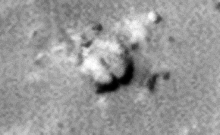 Underground entrance-way with arch consisting of two circular features or is this perhaps a crashed craft?