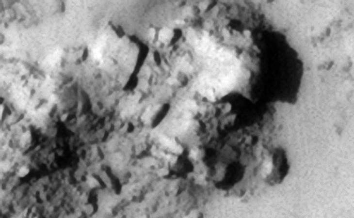 Shelter, mine, underground entrance-way? Metallic-plates and machine parts strewn about?