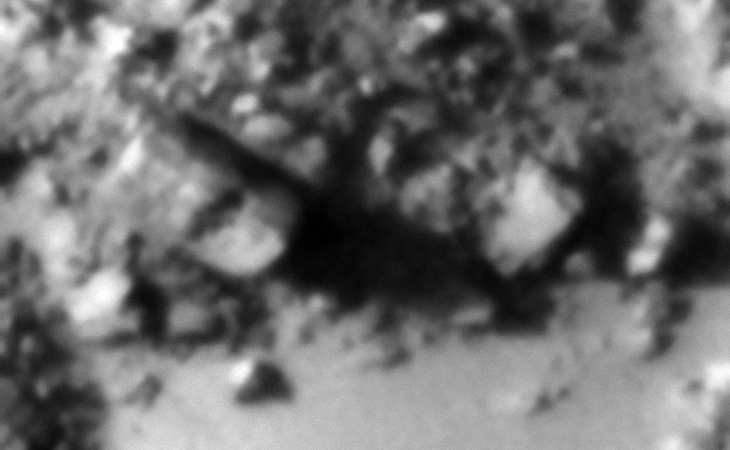 To the left what looks like a megalithic rectangular block with a long narrow hole or slot cut into the one corner